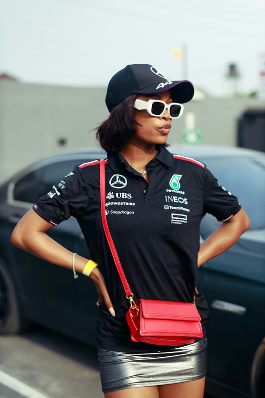 Woman wearing a black mercedes-amg petronas formula one team shirt.